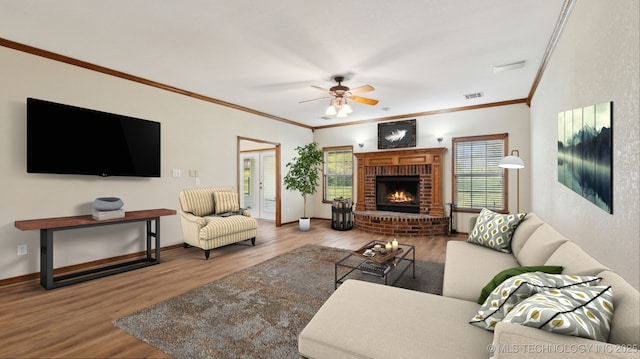1805 College Park Rd, Claremore, OK 74017 - living area featuring wood finished floors, crown molding, a fireplace, ceiling fan, and baseboards