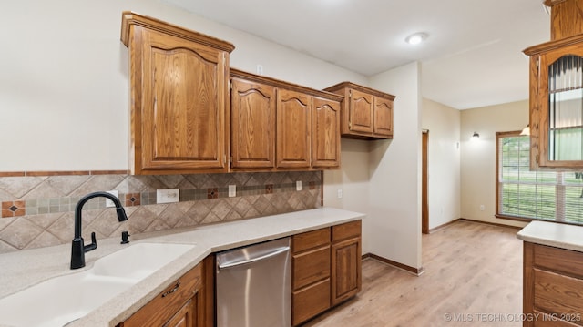 1805 College Park Rd, Claremore, OK 74017 - kitchen with dishwasher, a sink, backsplash, and brown cabinets
