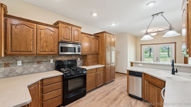 1805 College Park Rd, Claremore, OK 74017 - kitchen with stainless steel microwave, black gas range, a sink, brown cabinets, and recessed lighting