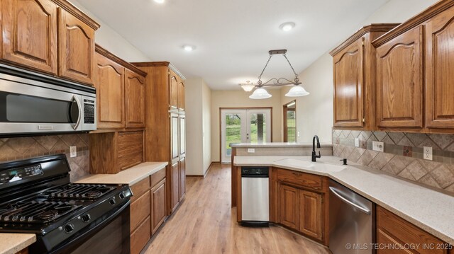 1805 College Park Rd, Claremore, OK 74017 - kitchen with stainless steel appliances, a sink, french doors, brown cabinets, and recessed lighting