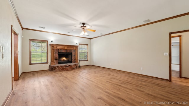 1805 College Park Rd, Claremore, OK 74017 - unfurnished living room with ornamental molding, a ceiling fan, light wood-style flooring, baseboards, and a brick fireplace