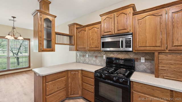 1805 College Park Rd, Claremore, OK 74017 - kitchen with stainless steel microwave, black gas stove, tasteful backsplash, and light countertops