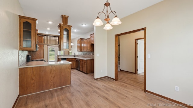 1805 College Park Rd, Claremore, OK 74017 - kitchen with stainless steel dishwasher, a sink, decorative backsplash, light wood finished floors, and light countertops