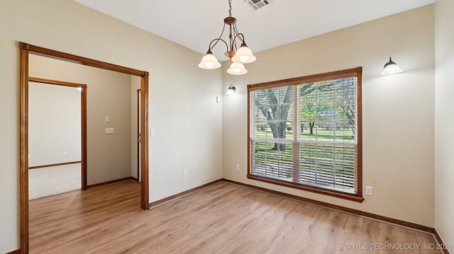 1805 College Park Rd, Claremore, OK 74017 - spare room featuring light wood finished floors, baseboards, and a chandelier