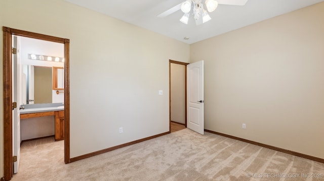 1805 College Park Rd, Claremore, OK 74017 - unfurnished bedroom featuring light colored carpet, baseboards, ensuite bath, and ceiling fan