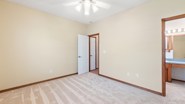 1805 College Park Rd, Claremore, OK 74017 - unfurnished bedroom featuring light colored carpet, baseboards, connected bathroom, and a ceiling fan