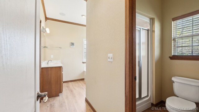 1805 College Park Rd, Claremore, OK 74017 - bathroom with vanity, a shower stall, wood finished floors, toilet, and crown molding