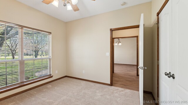 1805 College Park Rd, Claremore, OK 74017 - unfurnished room featuring ceiling fan, light colored carpet, baseboards, and a smoke detector