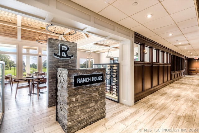 7001 E Oakland St, Broken Arrow, OK 74014 - wine room with light wood finished floors, a stone fireplace, and a chandelier