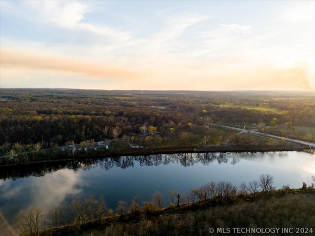 aerial view at dusk with a water view