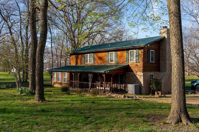 rear view of property featuring a yard