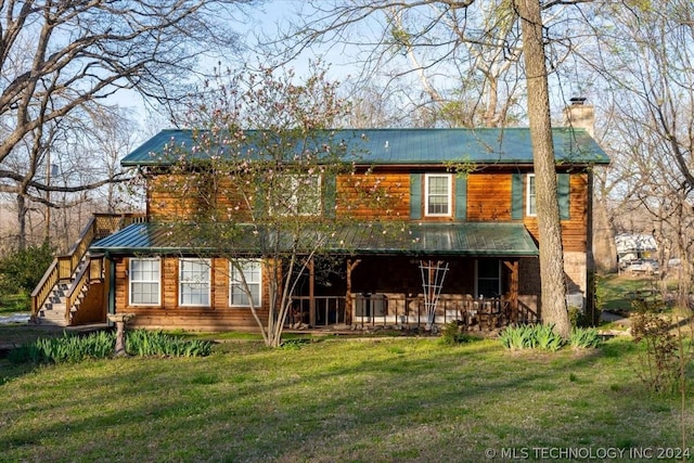 back of house featuring a yard