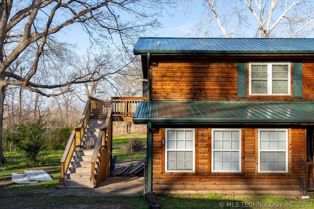 view of side of property featuring a wooden deck