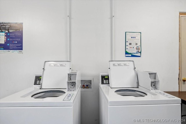 clothes washing area with washer and clothes dryer