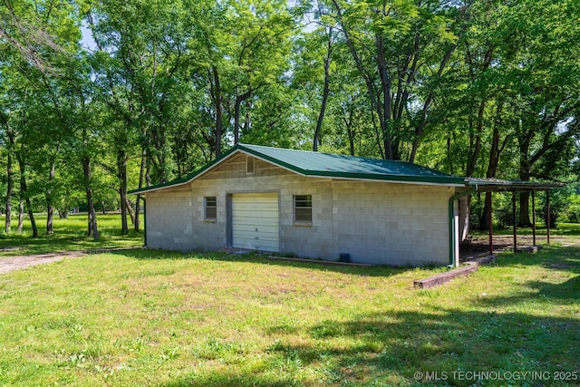 9596 N 447th Rd, Spavinaw, OK 74366 - view of home's exterior with concrete block siding, a yard, and a detached garage