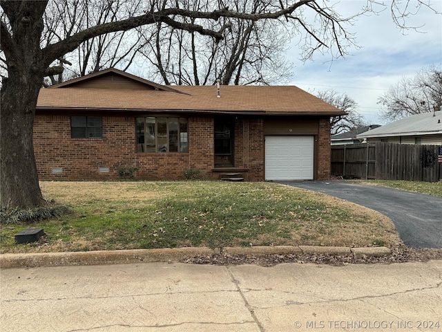 view of front of property featuring a garage and a front yard