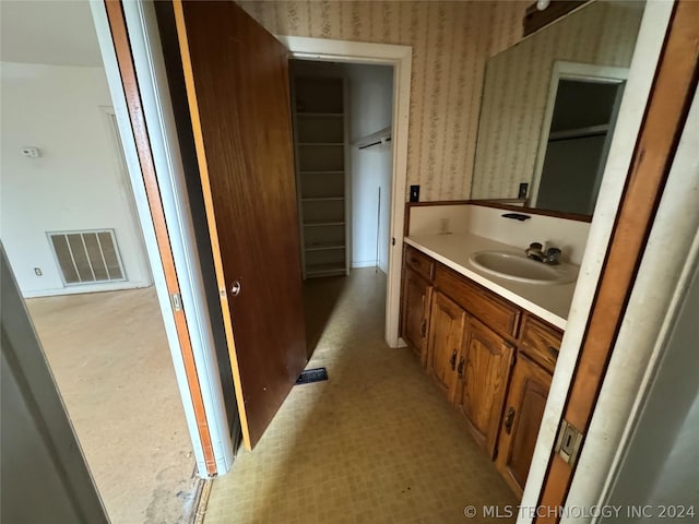 bathroom featuring tile flooring and vanity