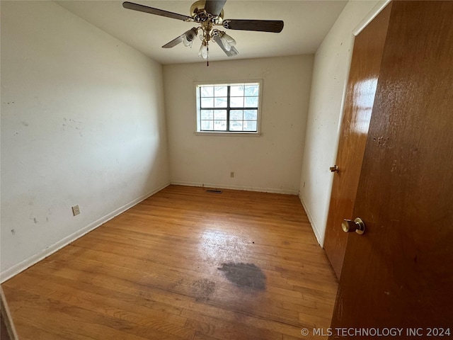 empty room featuring hardwood / wood-style floors and ceiling fan