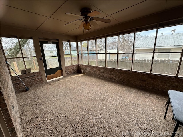 unfurnished sunroom featuring ceiling fan