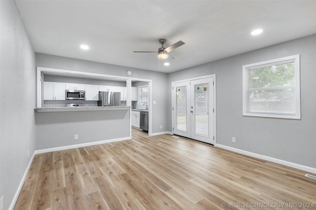 unfurnished living room featuring light wood finished floors, baseboards, a ceiling fan, french doors, and recessed lighting