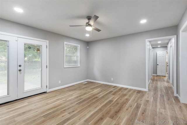 spare room featuring light wood-style floors, recessed lighting, french doors, and baseboards