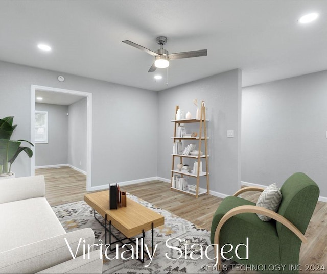 living area with light wood finished floors, recessed lighting, a ceiling fan, and baseboards