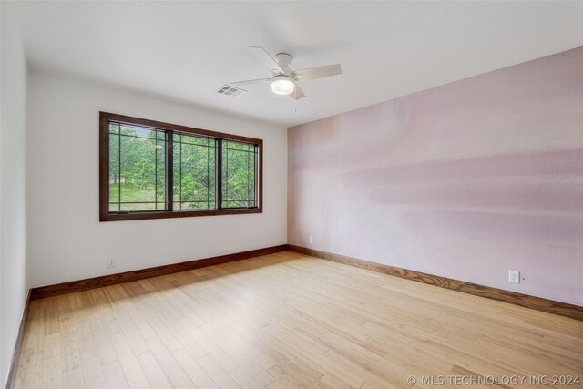 unfurnished room with ceiling fan and light hardwood / wood-style flooring