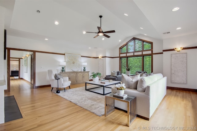 living room featuring light hardwood / wood-style flooring, high vaulted ceiling, and ceiling fan