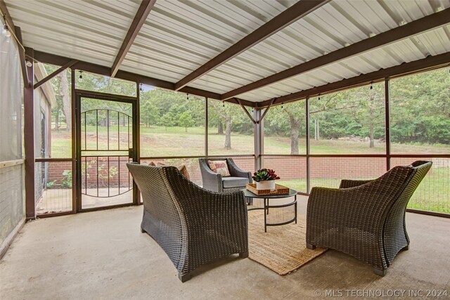 sunroom featuring a wealth of natural light and beam ceiling