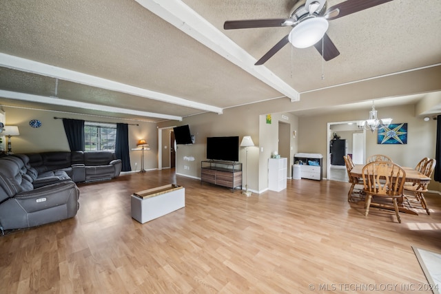 living room featuring a textured ceiling, beam ceiling, hardwood / wood-style flooring, and ceiling fan with notable chandelier