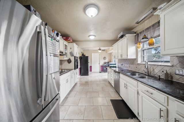 kitchen featuring stainless steel appliances, sink, and white cabinets