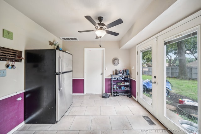 kitchen with stainless steel refrigerator, light tile patterned floors, french doors, and ceiling fan