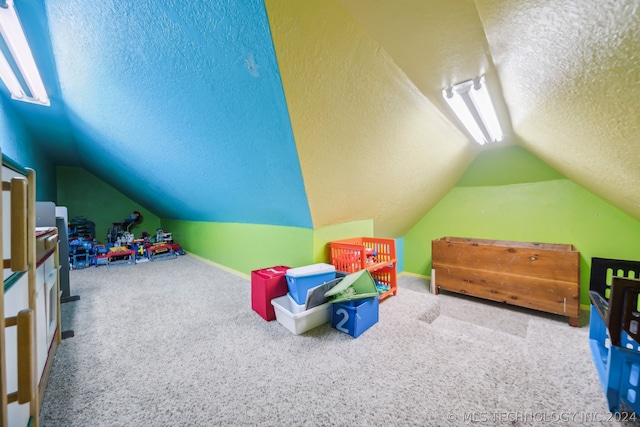 game room featuring lofted ceiling, carpet floors, and a textured ceiling