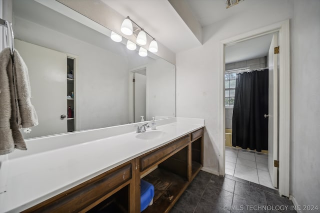 bathroom featuring tile patterned flooring, shower / bath combo with shower curtain, and vanity