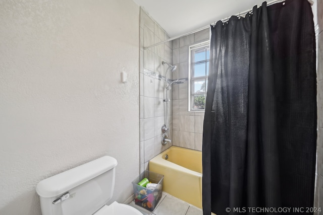 bathroom with toilet and shower / bath combination with curtain