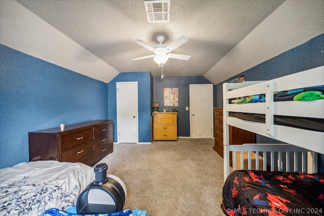 bedroom with a textured ceiling, light carpet, lofted ceiling, and ceiling fan