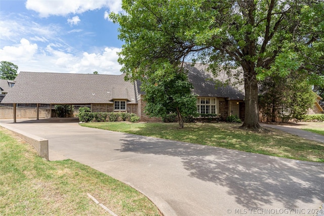 view of front of property with a front yard and a carport