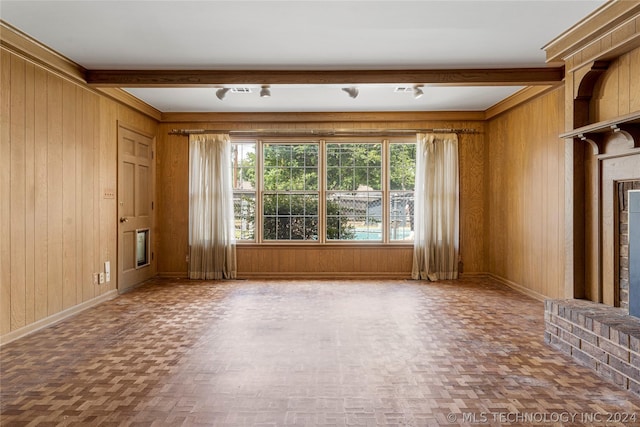 unfurnished living room featuring wood walls and parquet flooring