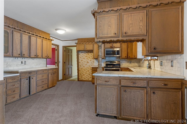 kitchen with sink, light colored carpet, and appliances with stainless steel finishes