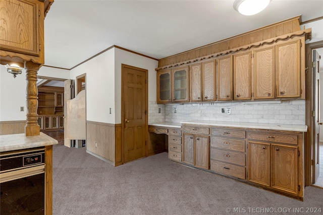 kitchen with tasteful backsplash, crown molding, and light colored carpet