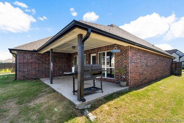 back of property featuring a yard and a patio area