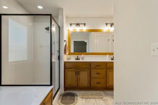 bathroom with plus walk in shower and vanity