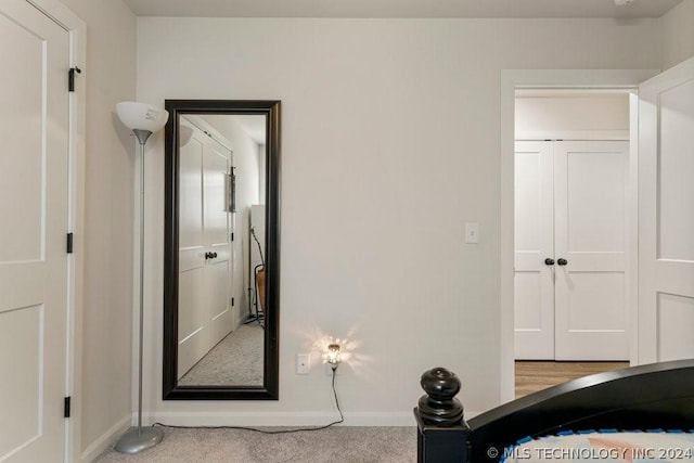 unfurnished bedroom featuring light carpet