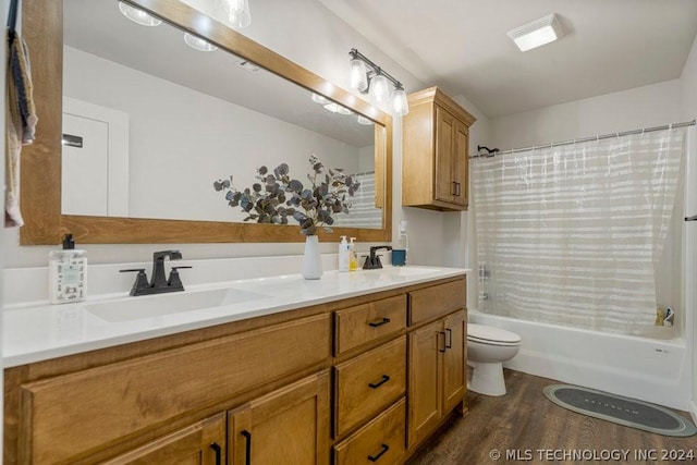 full bathroom with vanity, hardwood / wood-style floors, shower / bath combo, and toilet