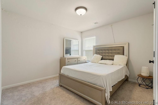 bedroom with light colored carpet