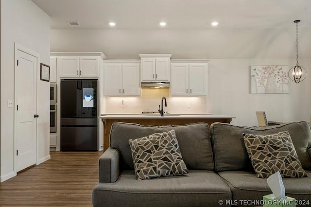 living room featuring sink and dark hardwood / wood-style flooring