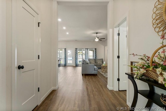 corridor with hardwood / wood-style floors