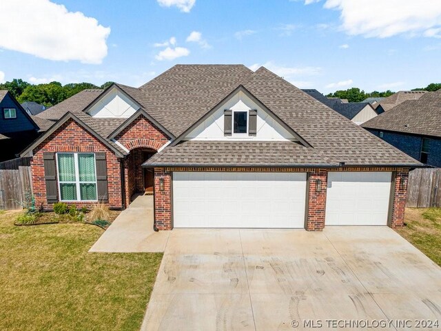 view of property with a front yard and a garage