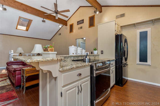 kitchen with black fridge, stainless steel electric stove, vaulted ceiling with beams, and dark hardwood / wood-style flooring