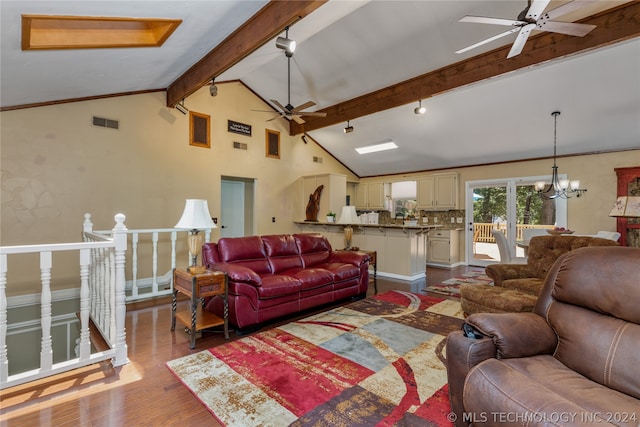 living room with wood-type flooring, lofted ceiling with beams, and ceiling fan with notable chandelier